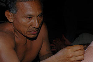 matse shaman administering medicine during ceremony