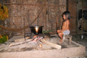 Matsés child watching pot boil