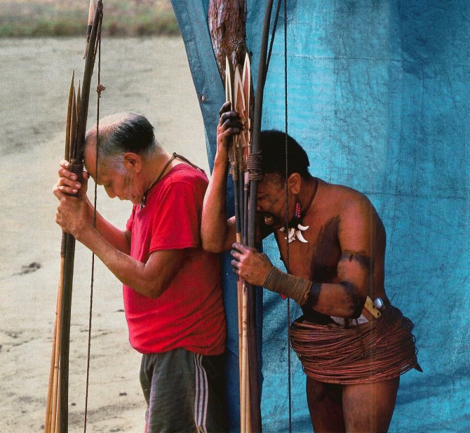 Urueu-Wau-Wau chieftan and younger warrior debating what do do about intruders on their territory.